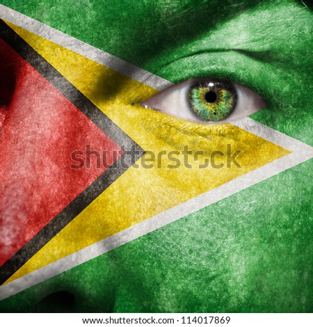 Flag painted on face with green eye to show Guyana support