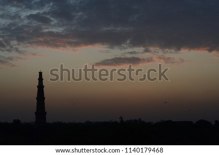 A view of Qutub Minar on a cloudy day in Delhi, India