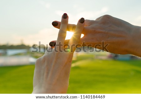 Hands show gesture symbol hashtag is viral, web, social media, network. Background is sunny urban sunset, concept for marketing, trending, blogging and internet themes