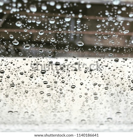 Raindrops on a window glass. Seasonal concept