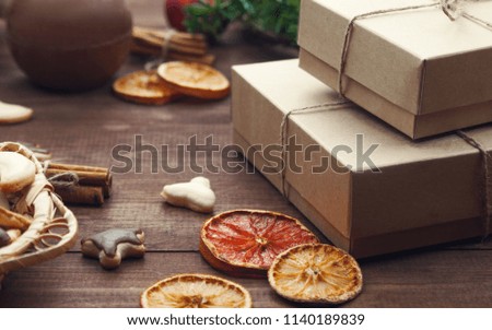 Top  view  of Christmas background. Christmas presents,cookies and dry oranges on a brown wooden table.