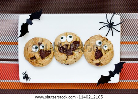 Halloween cookie, chocolate american cookies with candy eyes and chocolate chips, halloween treats for kids