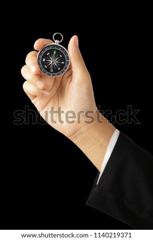 Businesswoman hand holding vintage retro compass isolated on black with clipping path, Instrument that indicates magnetic north.