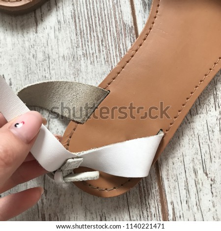 White sandals on a wooden background