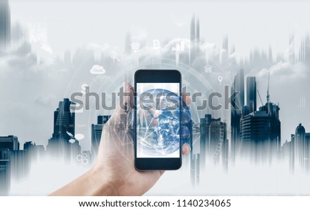 Hand using mobile smartphone with global network connection. Mobile internet connection and mobile application technology. Element of this image are published by NASA Royalty-Free Stock Photo #1140234065