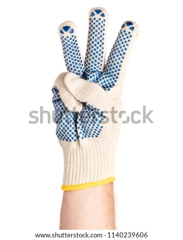 Worker showing three fingers up gesture. Male hand wearing working cotton glove with blue rubber dots, isolated on white background.