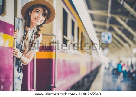 traveler on the train, Attractive Asian young pretty girl at the train station, Travel lifestyle and seasonal vacation concept.