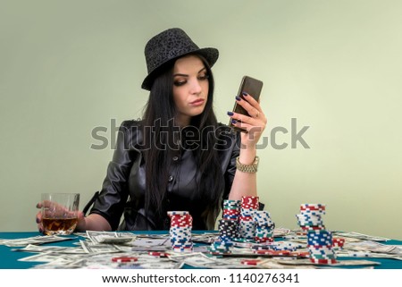 Glamorous girl in casino with mobile phone