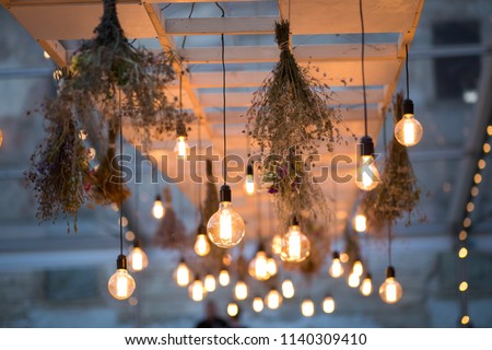 Rustic light bulb garden lights  Royalty-Free Stock Photo #1140309410