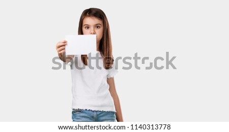 Full body little girl smiling confident, offering a business card, has a thriving business, copy space to write whatever you want