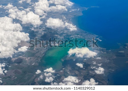 Aerial photo above Greece and Greek islands showing amazing shore, clouds, sea and Mediterranean natural land patterns  