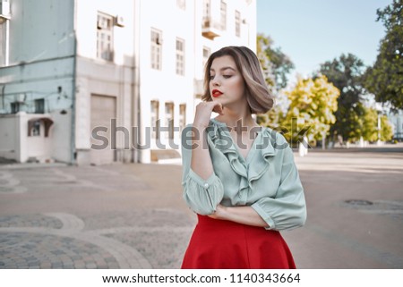  woman in the city center, building in the background                              