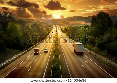 Highway traffic in sunset Royalty-Free Stock Photo #114034636