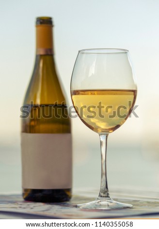 a reflection of the sky in a glass of wine