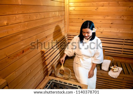 Beautiful Asian woman in sauna room.