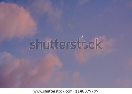 The moon and sunset colors in the sky, in Covington, Kentucky.