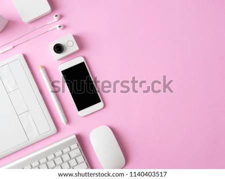 top view of office desk workspace with smartphone, notebook, graphic tablet, keyboard and mouse on pink color background with copy space, graphic designer, Creative Designer concept.