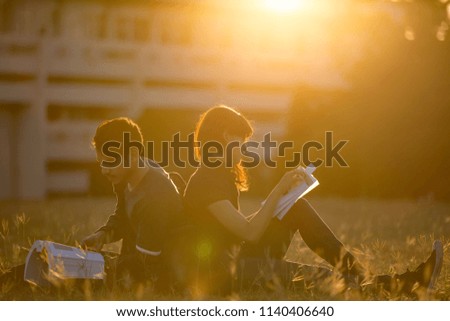 Student was reading in the outdoors and good weather. And they're happy.lens flare