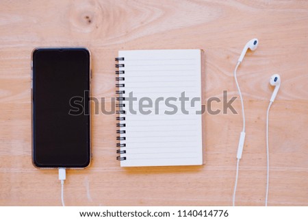 Minimal work space - Creative flat lay photo of workspace desk with notebook and mobile phone with blank screen  on copy space white background.Top view, flat lay photography.