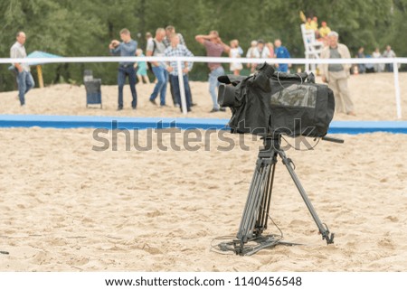 Television camera on the river beach. Camera for taking pictures on the beach.