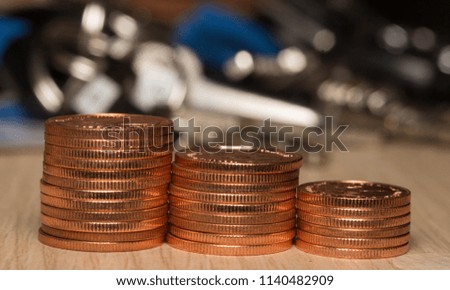 Stack of the coins on rustic wooden table