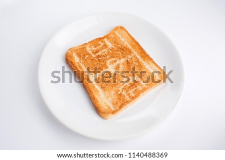 Pattern (picture) in the form of a silhouette of a football (soccer) field on a toasted bread on a plate on a white background