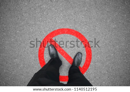 Businessman in black shoes standing on the wrong place that prohibited and not allowed. Business concept. Royalty-Free Stock Photo #1140512195