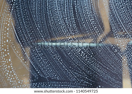 Stylish soap foam bubbles on a glass material isolated blurry photograph