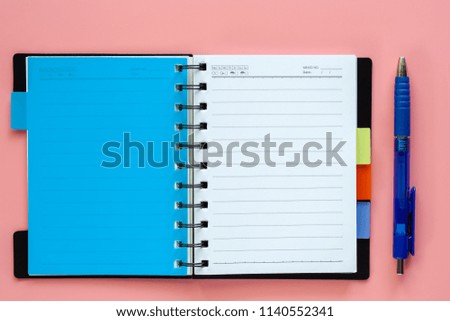 Opened blank notebook with pen on pink background for education and office supplies. Back to school concept