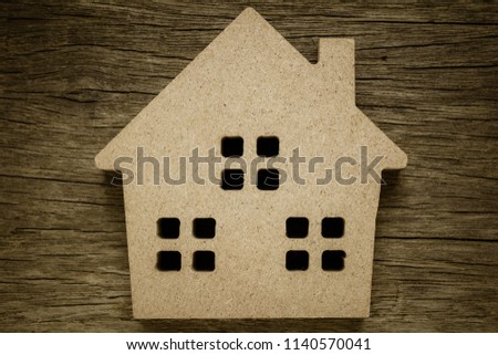 brown wood home icon on old abandoned wood background.