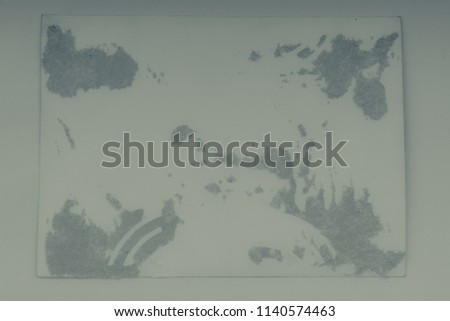Vintage and antique art concept. Front view of blank old aged dirty photo frame texture with stains and scratches on abstract blurred background. Detailed closeup studio shot.