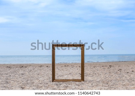 vintage photo frame on sand beach.
