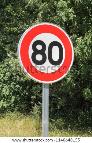 Speed limit traffic sign 80 on the road in France