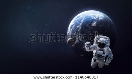 Astronaut in open space near the Earth and Moon. Place for text and infographic. Abstract wallpaper. Elements of this image furnished by NASA