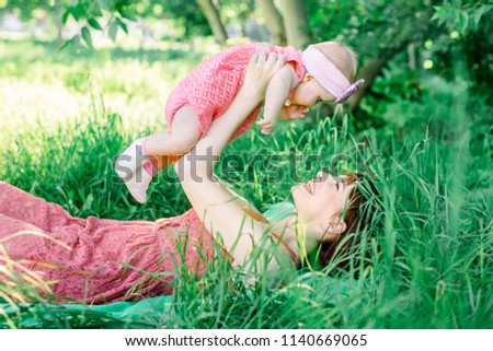 Baby with mother outdoors close to nature and have fun