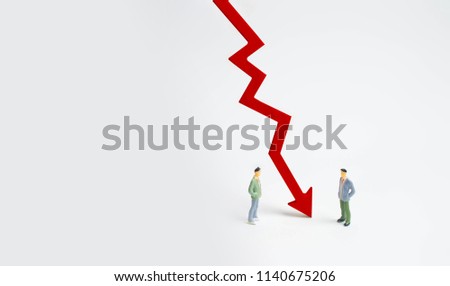 A wooden red chart arrow down divides the two people discussing the case. Termination and breakdown of relations, breaking ties. Contract break, conflict of interests. Negotiations of businessmen.