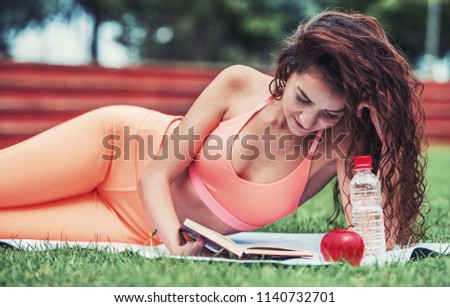 Relaxing after fitness. Young woman take a little break after training outdoor. Fitness, sport, lifestyle concept. Royalty-Free Stock Photo #1140732701