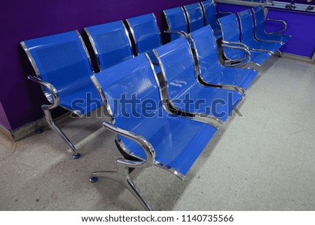 Blue chairs in ordinary empty waiting room