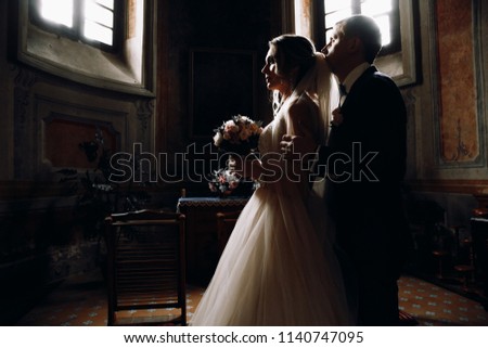 Bride and groom in the Church.Beautiful wedding photos of a couple.Couple in love.Wedding dress and bouquet