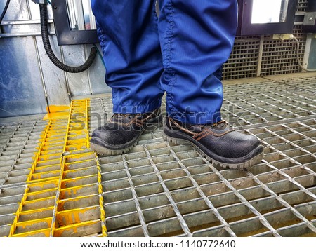 Close up safety shoes's men use for protection accident in factory. Royalty-Free Stock Photo #1140772640