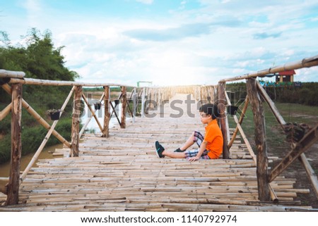 young homeless boy crying on the Thailand nation bridge