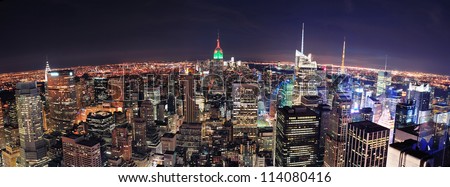New York City skyline aerial panorama view at night with Empire State Building, Times Square and skyscrapers of midtown Manhattan.
