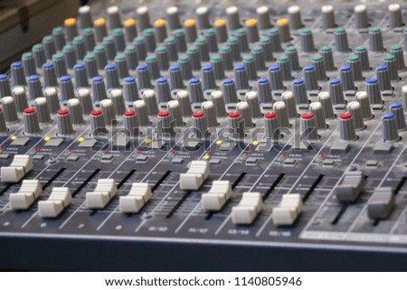 Sound recording studio mixing desk. Music mixer control panel. Closeup. Selective focus.