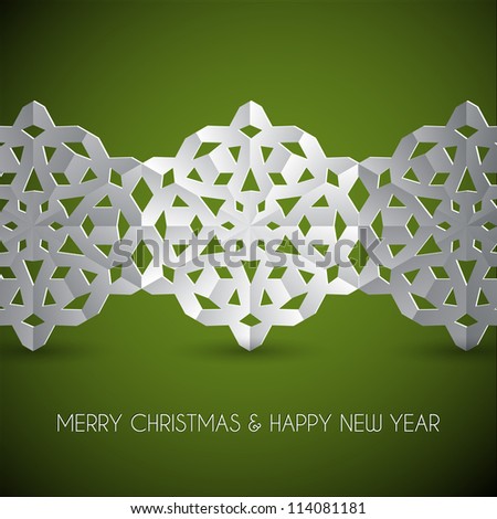 Vector white paper christmas snowflakes on a green background