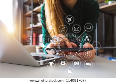  Woman using smart phone for mobile payments online shopping,omni channel,sitting on table,virtual icons graphics interface screen in morning light
 Royalty-Free Stock Photo #1140817097