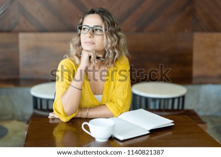 Pensive creative woman thinking about work. Attractive young business woman planning work when drinking coffee. Freelance concept