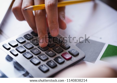 Close up hand of businesswoman or accountant working on calculator to calculate business data, and accountancy document. Business financial and accounting concept. Royalty-Free Stock Photo #1140838214