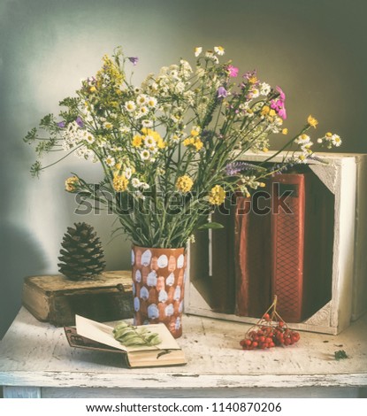still life with a bouquet of flowers and books. vintage. retro.