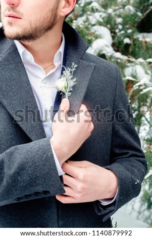 portrait of the bridegroom at the winter wedding