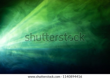 colorful beautiful spotlight . wide lens projector with light beam for movie and cinema at night . close up texture abstract smoke background . screening for multimedia . Royalty-Free Stock Photo #1140894416